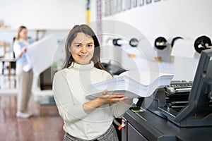 Portrait of positive woman printing office worker