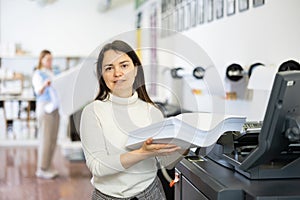 Portrait of positive woman printing office worker
