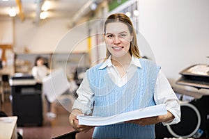 Portrait of positive woman printing office worker