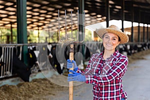 Portrait of a positive woman standing on a livestock farm