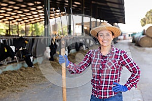 Portrait of a positive woman standing on a livestock farm