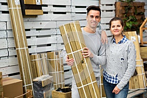 Portrait of positive young couple in hardware store