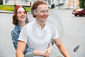 Portrait of a positive young couple riding on a motorbike