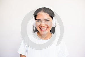 Portrait of positive young woman listening to music