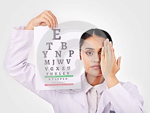 Portrait, poster and eye test with a woman optician in studio on a white background for vision or eyesight. Face