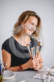 Portrait of Potter with brushes in her workplace