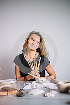 Portrait of Potter with brushes in her workplace