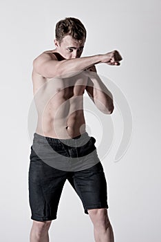 Portrait of powerful fighter male in fighting stance