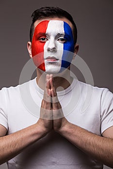 Portrait of Pray France football fan in game of France national team look at camera.