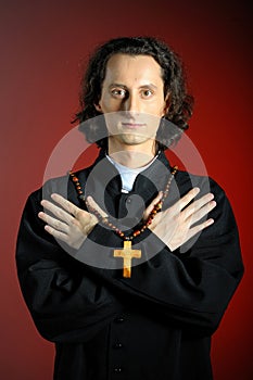portrait of Praying priest with wooden cross