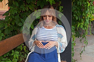 Portrait of pregnant woman resting outdoor, happy pregnancy concept.