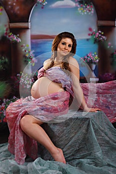 Portrait of a pregnant woman sitting