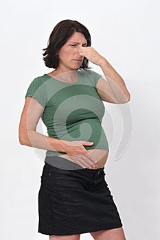 Portrait of a pregnant woman stuffy nose on white background