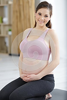 portrait pregnant woman on yoga mat