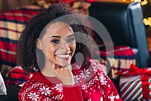 Portrait of pretty adorable girl toothy smile hand touch chin enjoy fairy new year time apartment indoors