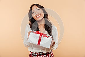 Portrait of a pretty asian woman holding gift box