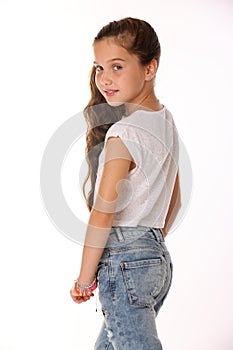 Portrait of lovely beautiful slender child girl in blue jeans