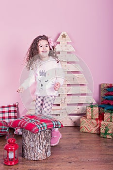 Portrait of pretty beautiful sweet little girl in Christmas interior