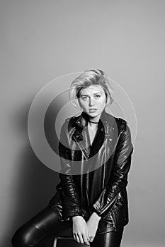 Portrait of a pretty blonde woman, wearing black biker jacket