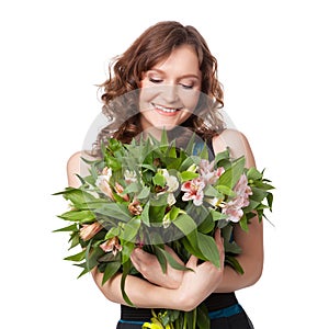 Portrait of pretty brunette holding bouquet of flowers