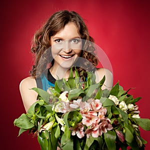 Portrait of pretty brunette holding bouquet of flowers