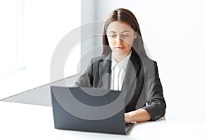 Portrait of pretty business woman with laptop in the offic