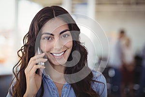 Portrait of pretty businesswoman talking on mobile phone