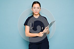 Portrait of a pretty Caucasian nurse wearing scrubs in a studio