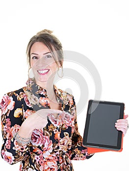 Portrait pretty charming confident trendy woman in casual pointing tablet in hands looking at camera isolated on white background