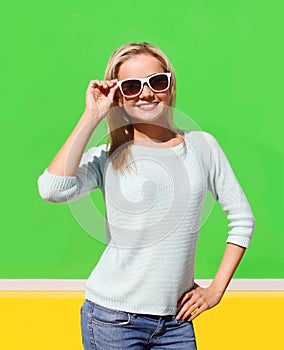 Portrait of pretty cool smiling girl in sunglasses having fun