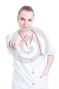 Portrait of pretty female doctor pointing one finger