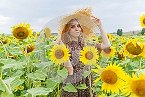 Portrait of a pretty girl in a field of sunflowers