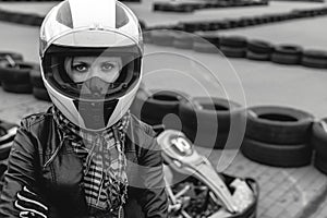 Portrait of a pretty girl wearing a white helmet close up, detail of Go-kart. karting track racing, copy space. serious look,