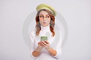 Portrait of pretty girlish wavy-haired girl using cell creating post pout lips isolated over light gray white color