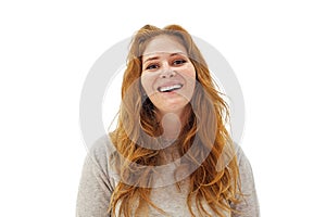 Portrait of pretty healthy beauty redhead woman with long healthy ginger curly hair laughing on white studio wall background