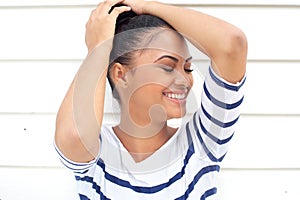 Portrait of a pretty hispanic girl smiling on white background