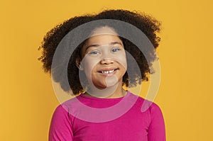 Portrait of pretty little black girl smiling and looking at camera