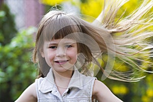 Portrait of a pretty little long-haired blond preschool girl in