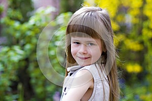 Portrait of a pretty little long-haired blond preschool girl in