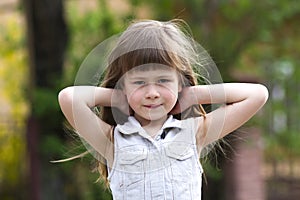 Portrait of a pretty little long-haired blond preschool girl in