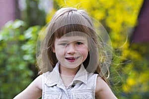 Portrait of a pretty little long-haired blond preschool girl in