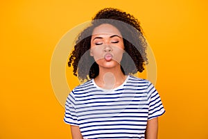 Portrait of pretty lovely girl closed eyes dream kiss lips nice wavy hairdo isolated on yellow color background