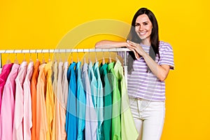 Portrait of pretty lovely girl hands arms lean rack trendy striped outfit look camera isolated on yellow color