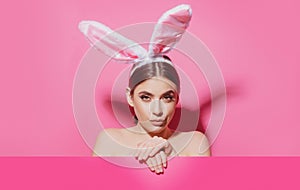 Portrait of a pretty lovely girl wearing bunny ears isolated on pink banner, copy space. Blank poster banner.
