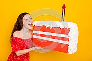 Portrait of pretty positive person open mouth hold large slice of cake isolated on yellow color background