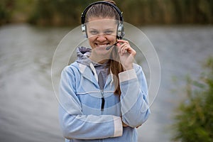 Portrait of a pretty smiling customer service operator wearing a headset