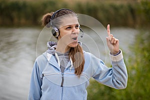 Portrait of a pretty smiling customer service operator wearing a headset