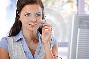 Portrait of pretty smiling dispatcher in work