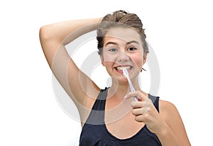 Portrait of pretty smiling teen brushing her teeth isolated on white background