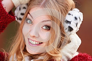 Portrait of pretty smiling woman in fur earmuffs.